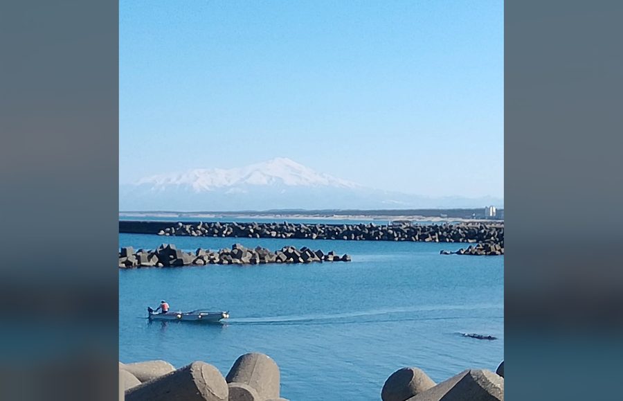 海と雪山を望む三陸沿岸の風景